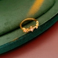 Detailed close-up of a vintage gold ring featuring three zircon-studded butterfly elements - Copper/Zirconia / Ring / Gold-Pink