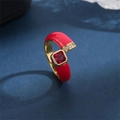 Elegant gold ring with red enamel and square red zircon gemstone on dark background - Red