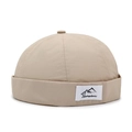 Lightweight beige docker hat with a mountain logo patch in a minimalist style - Adjustable / Light Beige