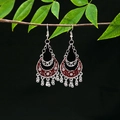 Macro detail of vintage tribal silver earrings with red hollow pendants and tassels - Retro Silver Red Long Bell(E5002-1)