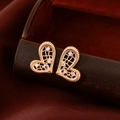 Macro shot of 18K gold plated hollow heart earrings with sparkling cubic zirconia crystals - Gold