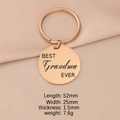 Detailed view of a rose gold keychain engraved with BEST Grandma EVER on pink fabric - Grandma / Rose Gold