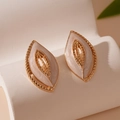 Detail of vintage gold leaf earrings with pearlescent enamel and twisted metal texture - Gold Enamel Leaf Style