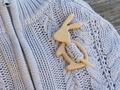 Close-up of wooden rabbit brooch pinned on light purple knit sweater for clothing detail - Rabbit