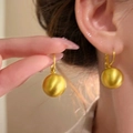 Elegant s925 silver needle gold-colored matte sphere drop earrings worn by a model - Matte Brushed Ball (E6899 Gold)