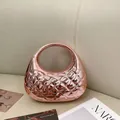 Detail of rose gold acrylic evening clutch with quilted texture and circular hollow handle - Nude