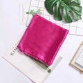 Silk satin square scarf in vibrant fuchsia pink displayed with modern aesthetic props - Rose Red