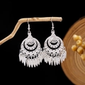 Detail of silver ethnic dangle earrings with leaf tassels on a wooden branch - Silver Multi-Layer Hollow Leaf Tassel Style (E2873-37)