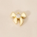 Macro detail of 18K gold-plated bow pendant with sparkling heart-shaped zircon stone - Heart Zirconia Bow (PJ0262) / Gold