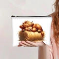 Detail of Highland Cow print on white portable makeup bag with black zipper closure - Sleeping Highland Cow on Hay (jiayingpbb0113)