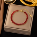 Elegant gold-plated stainless steel bracelet with red rectangular zircon stones on display - Gold with Red Zirconia