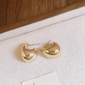 Macro detail of glossy golden chunky C-shaped hoop earrings on white fabric texture - Small J-shape (Steel Pin - Gold)