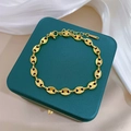 Gold-plated stainless steel coffee bean chain bracelet on a green jewelry box - Gold