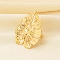 Close-up of golden monstera leaf ring on white silk, showing detailed hollow texture - Monstera Leaf Style (KR113711-SP)