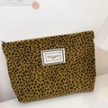 Portable corduroy cosmetic bag featuring a bold leopard print and zipper closure - Khaki Leopard Print
