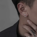 Macro shot of a silver curved diamond stud and minimalist hoop earrings on male ear - Single Right Ear