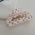 Detail of pink leopard and floral plaid pattern on cloud-shaped acrylic hair claw clip - Cream Leopard Cloud
