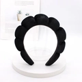 Detail of a thick black velvet padded headband with elegant cloud pleats on a white stand - Black