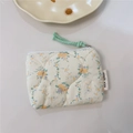 Close-up of floral quilted cotton pouch with zipper and simple wish label - Orange Pink Floral Quilted
