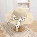 Detail of sun straw hat with wide wavy brim and polka dot ribbon bow decoration - 52cm (Recommended 1-3Y) / Hat / Beige