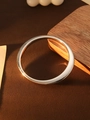 Polished silver CCB minimalist bangle with high-gloss metallic finish shown on wood - L156 Silver Flat Oval
