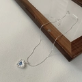 Collana in argento S925 con pendente a cuore e zircone blu su sfondo bianco testurizzato - Argento sterling 925 / Argento