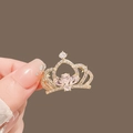Exquisite golden crown brooch with pink pear-cut crystals held by a hand display - 459# Crown