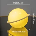 Astronaut planet night light in warm yellow with crater textures, 9.5cm width variant - Planet Lamp (Battery Powered)