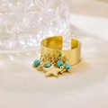 Detail of gold wide band ring with star charms and turquoise beads on satin background - R00901G (Smooth Wide Band + Star Pendant + Turquoise Bead)
