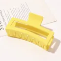 Detail view of a large rectangular matte yellow hair claw clip on a minimalist background - 13cm Rectangular - Matte Bright Yellow