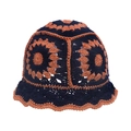 Close-up of navy and orange knit bucket hat with crochet flower pattern and wavy brim - Adjustable 56-60cm / Navy & Caramel Patchwork (E)