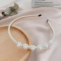 Detailed macro view of gold metal headband with white pearls on a soft pink satin surface - 12# Gold Base 6 Pearl Flowers Headband
