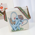 Beige canvas shoulder bag with blue elephant embroidery and colorful woven strap - Blue Elephant