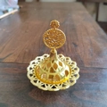 Macro detail of golden Arabic incense burner with hollow diamond pattern and palm tree top - Coconut Tree Top