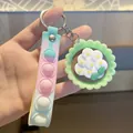 Porte-clés en silicone macaron avec pendentif fleur verte et bracelet à bulles pop - Oeuf sur le Plat Fleur