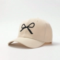 Detail of a beige baseball cap with black embroidered bow and premium canvas texture - One Size / Beige