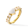 Macro shot of gold heart ring with center white gemstone and clear side stones - White