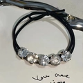 Detail of high-elasticity black hair tie featuring five large sparkling rhinestones - Black