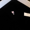 Macro shot of heart-shaped earring featuring pink gemstone and blue accent stone - Pink Heart with Blue Stone Accent