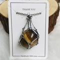 Polished tiger eye stone pendant in a silver metal cage on a silver chain necklace - Silver Tiger Eye