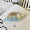Detail of triceratops hair claw with blue and orange marble texture on a book - Light Blue Triceratops