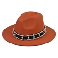 Detail of orange wool felt fedora featuring black ribbon and elegant white pearls - Orange Fedora with Pearl Chain