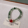 Macro shot of green phantom quartz bracelet with red agate bead on beige linen texture - Green Phantom Red Bead Accented Style (9#)