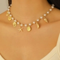 Detail of bohemian necklace with faux pearls, golden starfish, shell, and conch charms - Marine Pearl Beaded Necklace(WG-0134) / KC Gold