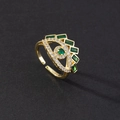 Detail of gold evil eye ring with green gemstones and adjustable open band design - Evil Eye Charm