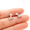 Close-up of minimalist stainless steel giraffe stud earrings held by hand to show size - Giraffe / Steel