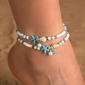 Adjustable beach anklet with blue starfish, white shells and pearls on a sandy background - Double Layer Blue Starfish Shell Pearl