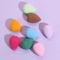 Set of 8 colorful teardrop makeup sponges in pink, yellow, and blue on purple surface - Teardrop-Bulk / Coffee
