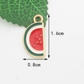Watermelon slice enamel pendant in red and green with golden metal edges, 1.6x0.8cm - Watermelon