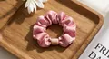 Detail of pink pleated satin scrunchie with apricot resin buckle on a wooden tray - Tencel Velvet Bean Paste Pink